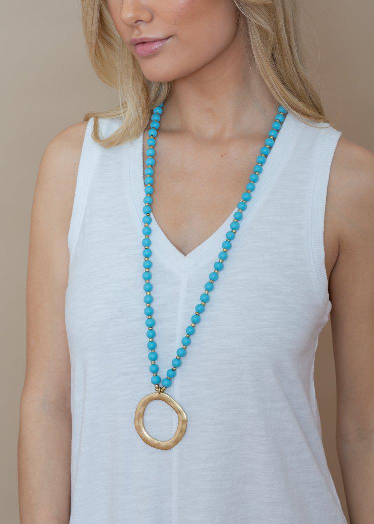 Snug Corner Long Beaded Turquoise Beaded Pendant-Hand In Pocket