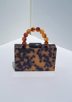 Gia Acrylic Clutch - Tortoise-Hand In Pocket